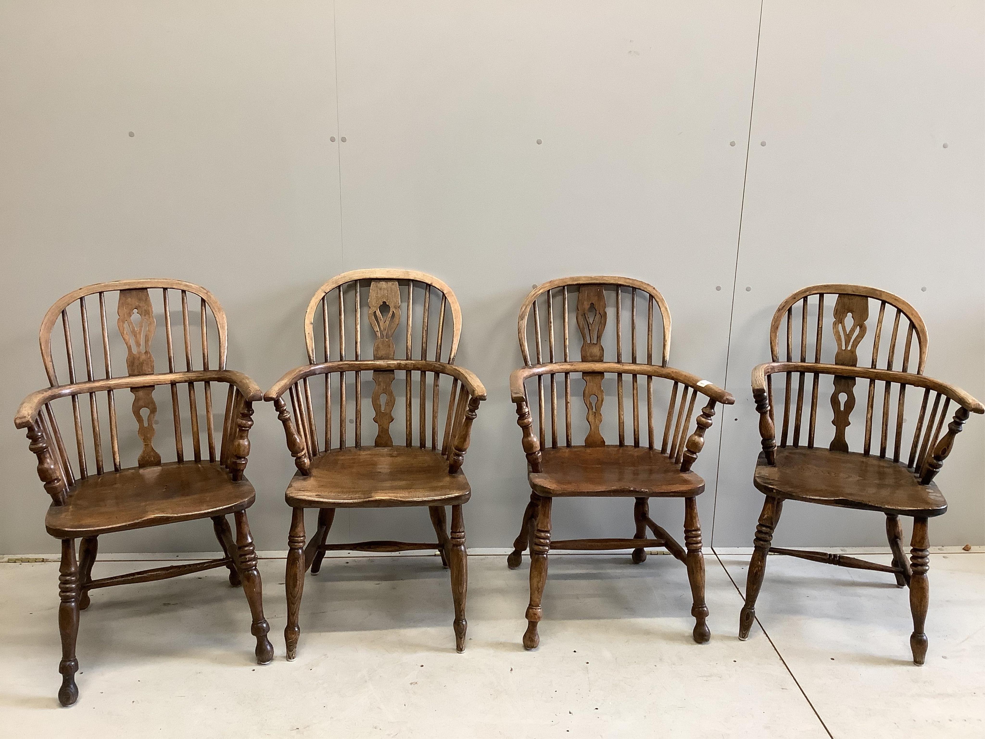 A harlequin set of four 19th century ash, elm and beech Windsor elbow chairs, largest width 60cm, depth 36cm, height 95cm. Condition - fair